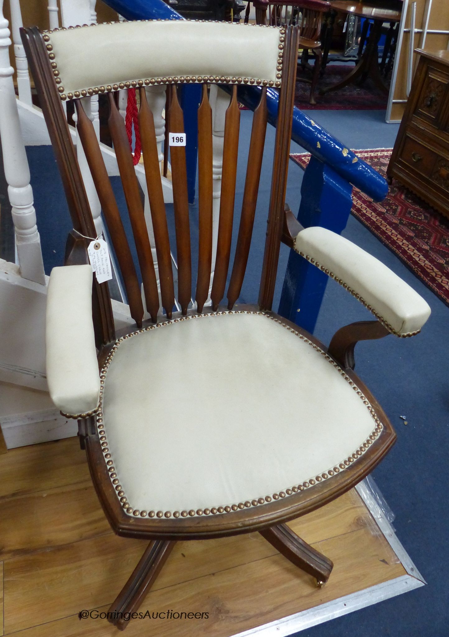 A late 19th century mahogany and cream leather swivel and rocking desk chair
